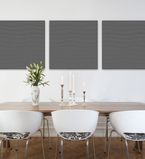 Light grey wall with three dark grey panels along the middle of the wall