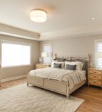 Beige bedroom with white mouldings and baseboards