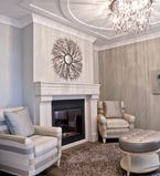 Living room with beige walls with white casing with metallic accented furniture