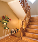 Oak staircase with white baseboards on the landing